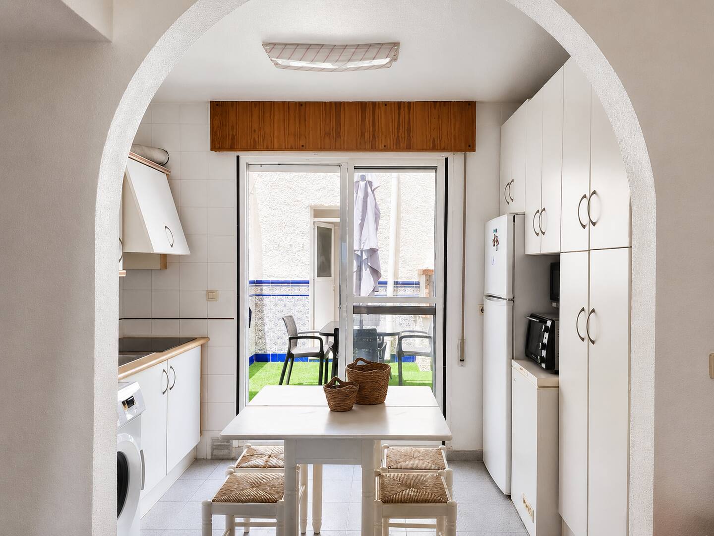 Open kitchen in wood and white tones